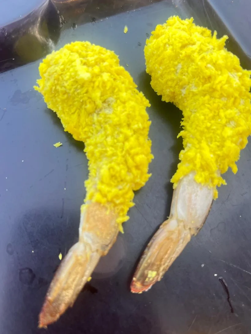 Prawns coated in golden yellow crumb